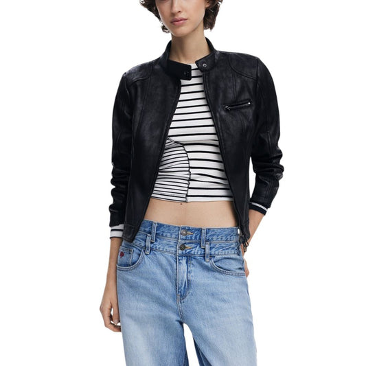 Person wearing a black leather jacket, striped top, and blue jeans on a white background
