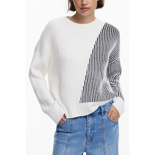 Person wearing a white sweater with black and white striped pattern on a white background