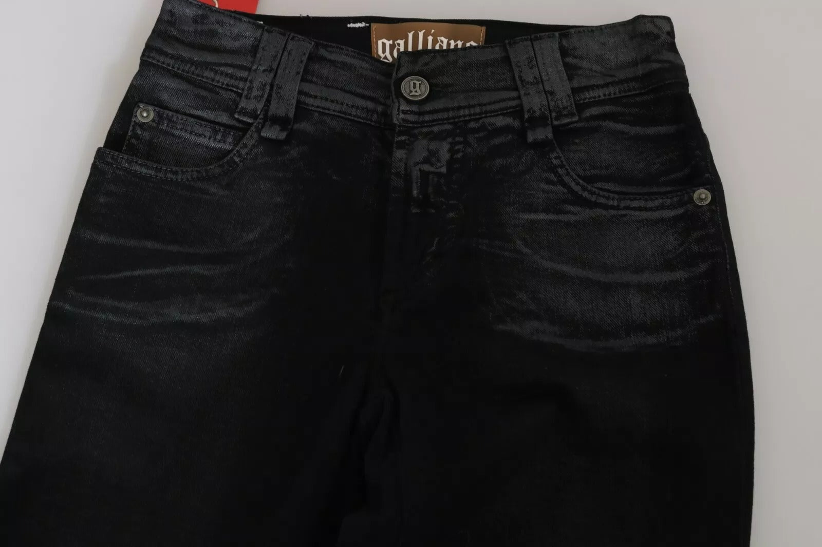 Black jeans with a brand label on a white background